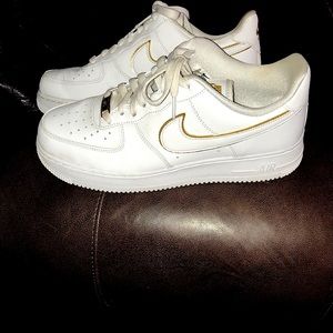 Nike Air Force 1 shoes with gold